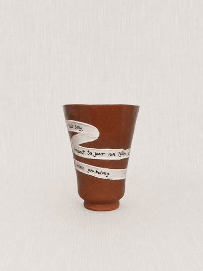 Close-up of the handwritten poem wrapped around the Energy Is Rising ritual vessel