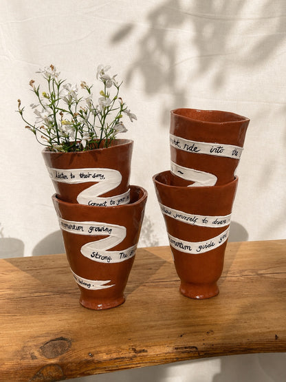 handmade ceramic ritual vessels with fresh flowers 