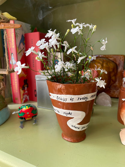 Energy Is Rising ceramic ritual vessel displayed with fresh flowers