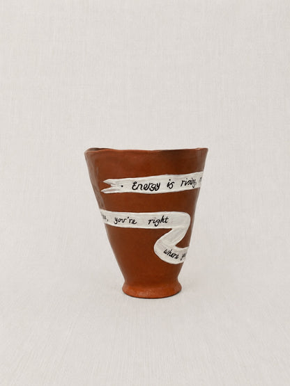 Close-up of the handwritten poem wrapped around the handmade ceramic ritual vessel