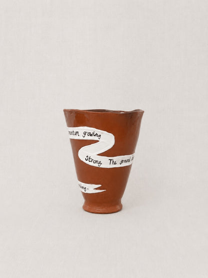 Close-up of the handwritten poem wrapped around the handmade ceramic ritual vessel