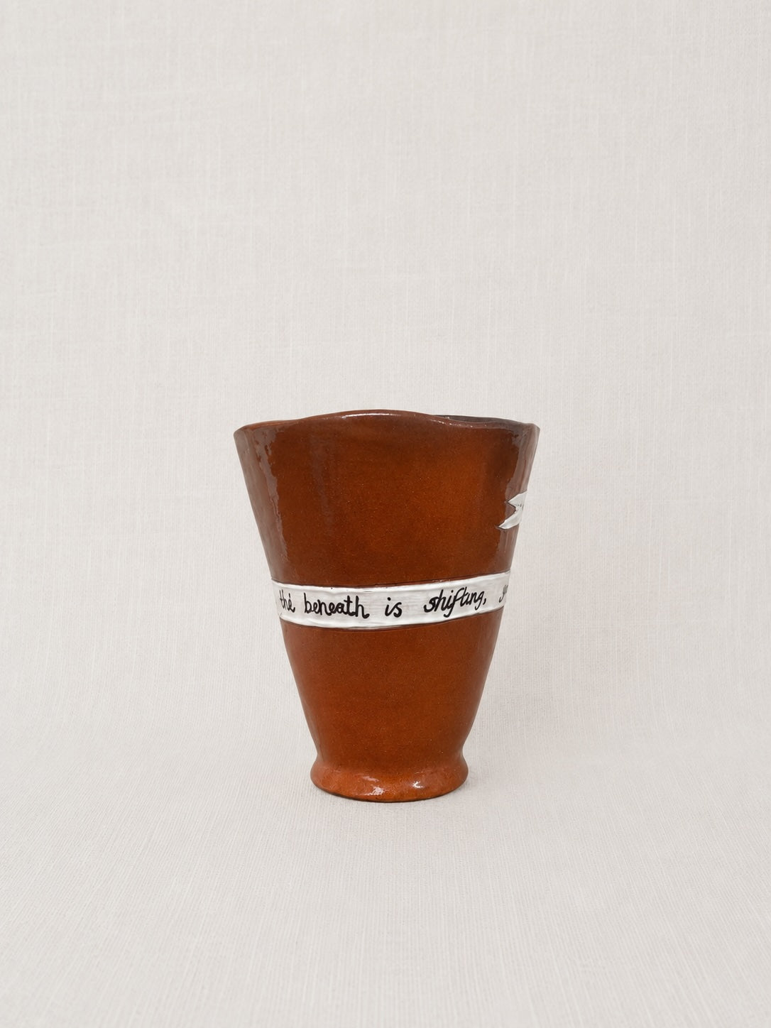 Close-up of the handwritten poem wrapped around the handmade ceramic ritual vessel