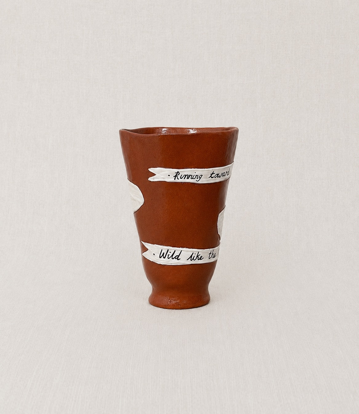Close-up of the handwritten poem wrapped around the handmade ceramic ritual vessel