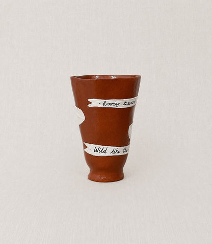 Close-up of the handwritten poem wrapped around the handmade ceramic ritual vessel