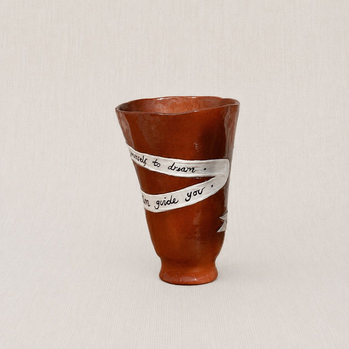 Close-up of the handwritten poem wrapped around the handmade ceramic ritual vessel
